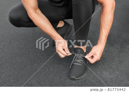 Young male jogger athlete training and doing workout outdoors in city. 81773442