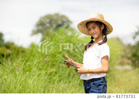 Outdoor Portrait Of A Little Girl Farmer On Rice Fields Outdoor Portrait Of A Little Girl Farmer On Rice Fields 81773731