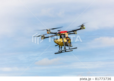 Agriculture drones glide above rice fields spraying fertilizer. Farmers used a drone to spray fertilizer on rice fields. Agriculture technology concept Agriculture drones glide above rice fields spraying fertilizer. Farmers used a drone to spray fertilizer on rice fields. Agriculture technology concept 81773736