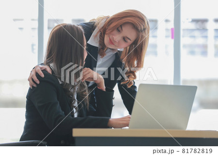 Woman sooth for tired Asian businesswoman using laptop 81782819