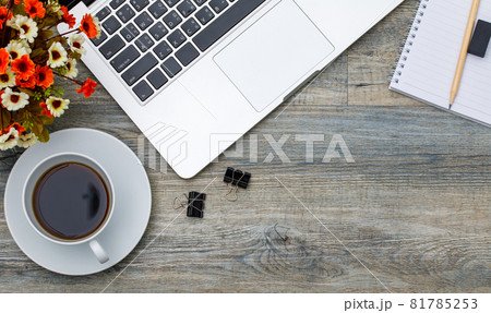 Top view photo of laptop notebook computer and coffee cup on wooden background and copyspace. Business working space concept 81785253