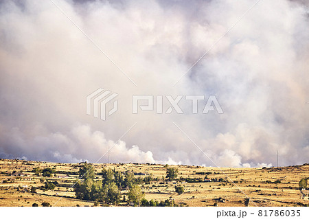 Dark and dense smoke clouds from a fire in Spain. Close-up of a large smoke cloud in the sky from a forest fire 81786035