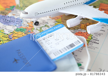 Passport plane ticket and toy plane stands on world map closeup 81786343