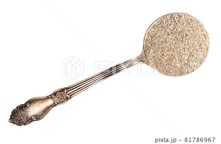 top view of rye bran in silver tablespoon cutout on white background 81786967