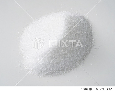 pile of crystalline extract of stevia plant sugar substitute closeup on white plate 81791342