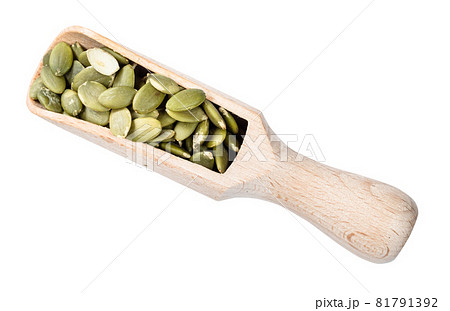 top view of peeled pumpkin seeds in wooden scoop cutout on white background top view of peeled pumpkin seeds in wooden scoop cutout on white background 81791392