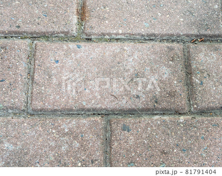 old granite stone tile on street pavement close up 81791404
