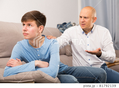Father scolding his turned away son 81792139