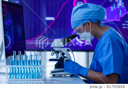 Researcher or scientist wearing protective hygiene mask working on microscope and test-tubes in lab. Researcher or scientist wearing protective hygiene mask working on microscope and test-tubes in lab. 81793608