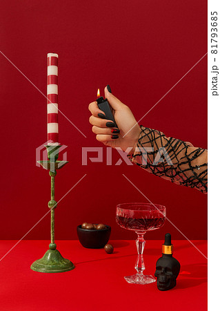 Womans hand with spooky nail design set the table. Halloween cocktail on red background 81793685