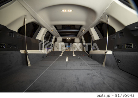 huge empty car trunk in premium light color interior of suv. rear seats in premium car folded in flat flor. rear view huge empty car trunk in premium light color interior of suv. rear seats in premium car folded in flat flor. rear view 81795043