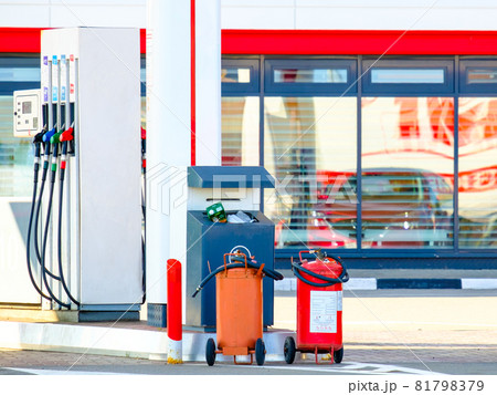 Hand-held fire extinguishers at gas stations to prevent fires. Hand-held fire extinguishers at gas stations to prevent fires. 81798379