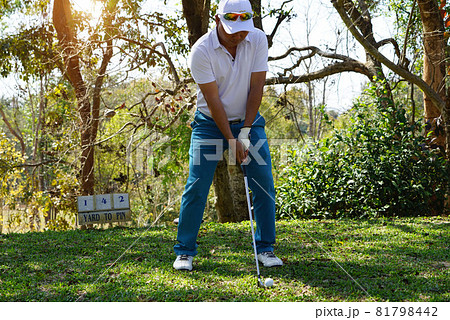 Golfer are playing game golf and hitting go on green grass mountain background. Asia male player game shot in summer. Sport holiday lifestyle concept. Golfer are playing game golf and hitting go on green grass mountain background. Asia male player game shot in summer. Sport holiday lifestyle concept. 81798442