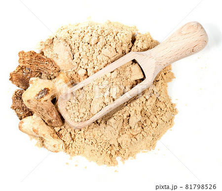 top view of wood scoop on pile of dried ginger roots and powder on white background 81798526