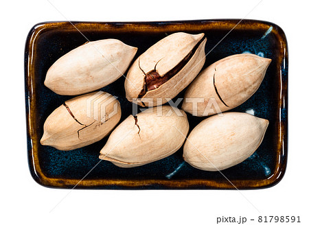 top view of unshelled pecan nuts in bowl cutout on white background top view of unshelled pecan nuts in bowl cutout on white background 81798591