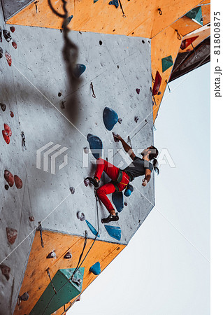Hard level. Young man professional rock climber practicing at training center in sunny day, outdoors. Concept of healthy lifestyle, tourism, nature, motion. 81800875