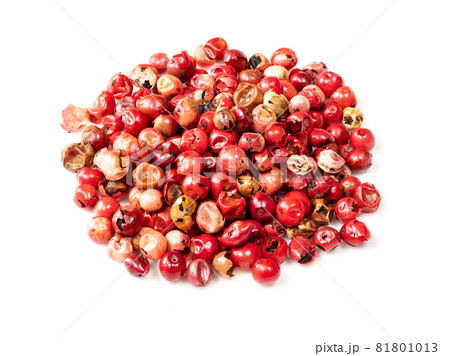 pile of pink peppercorns (Baie rose) closeup on white background 81801013