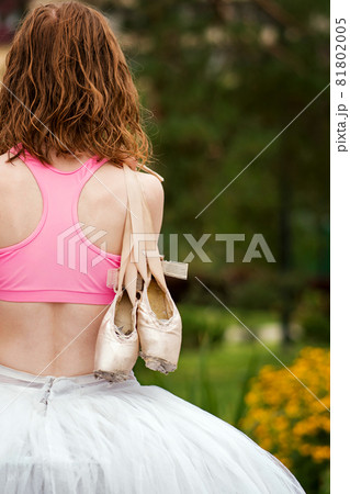 Unrecognizable ballet dancer in city street 81802005