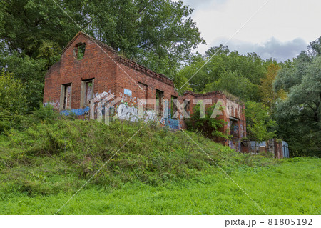Facade of an abandoned brick building of a water pumping station in a city park 81805192