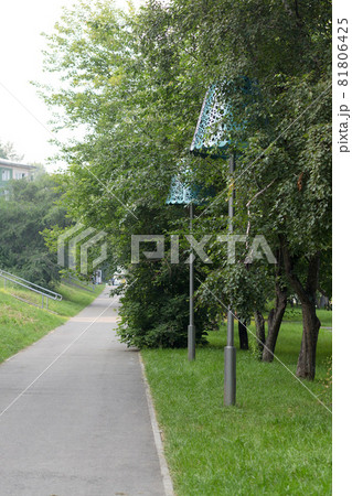 Large street lamp in the form of a table lamp in a city park Large street lamp in the form of a table lamp in a city park 81806425