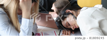 Tired business woman sleeping at table in office 81809245