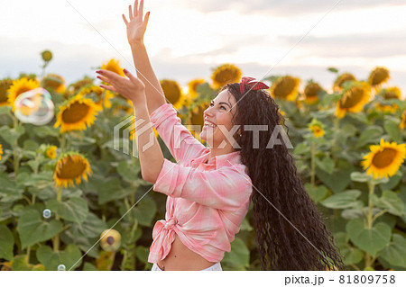 Cute brunette woman blowing soap bubbles. Cute brunette woman blowing soap bubbles. 81809758