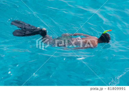A male tourist swims in a mask and fins on the Sea A male tourist swims in a mask and fins on the Sea 81809991