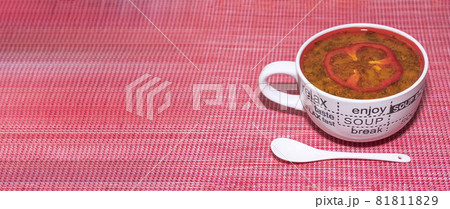 vegetable soup in a mug on a red background. banner vegetable soup in a mug on a red background. banner 81811829