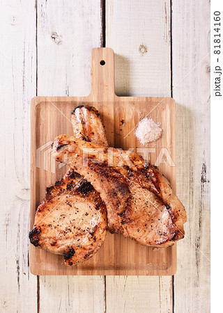 Two grilled tomahawk pork chops Two grilled tomahawk pork chops 81814160
