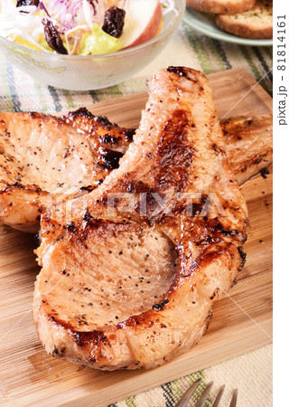 Two grilled tomahawk pork chops Two grilled tomahawk pork chops 81814161