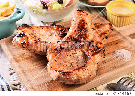 Two grilled tomahawk pork chops Two grilled tomahawk pork chops 81814162