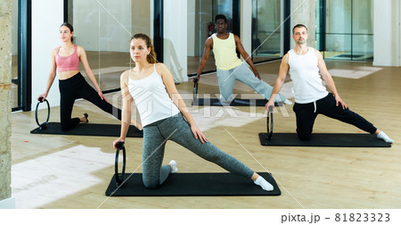 People exercising with pilates ring at class 81823323