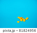 Yellow pills on blue background 81824956