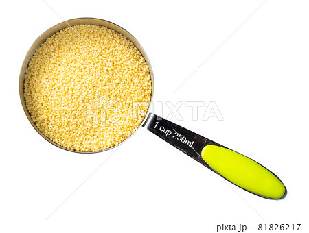 top view of raw North African couscous grains in measuring cup cutout on white background top view of raw North African couscous grains in measuring cup cutout on white background 81826217
