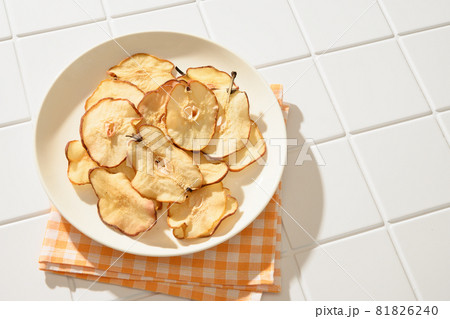 Pear chips on a white background. Vegan dessert sugar free. Pear chips on a white background. Vegan dessert sugar free. 81826240