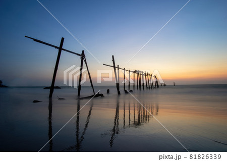 Sunset and reflections from the sea, decaying wooden bridges, Khao Pi Lai Phang Nga beach, Thailand 81826339