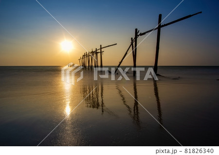 Sunset and reflections from the sea, decaying wooden bridges, Khao Pi Lai Phang Nga beach, Thailand Sunset and reflections from the sea, decaying wooden bridges, Khao Pi Lai Phang Nga beach, Thailand 81826340