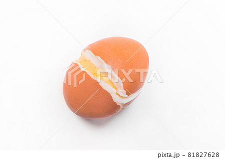Fresh boiled brown chicken egg burst with a crack on a white background isolated, close-up Fresh boiled brown chicken egg burst with a crack on a white background isolated, close-up 81827628