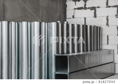 Pile of round metal pipes at a construction site. Storage steel tube industrial materials on warehouse 81827934
