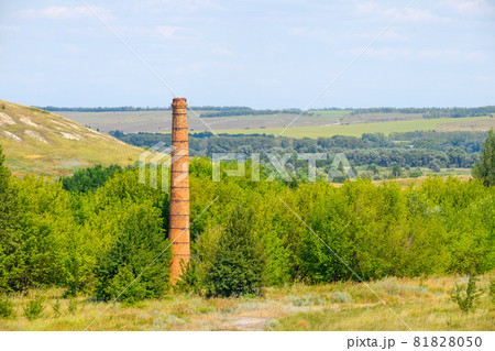 Old abandoned brick chimney against the backdrop of the landscape Old abandoned brick chimney against the backdrop of the landscape 81828050