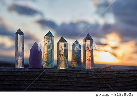 Healing Reiki Crystasls on wood with sea at sunset background. Healing stones at the seaside. Healing Reiki Crystasls on wood with sea at sunset background. Healing stones at the seaside. 81829005