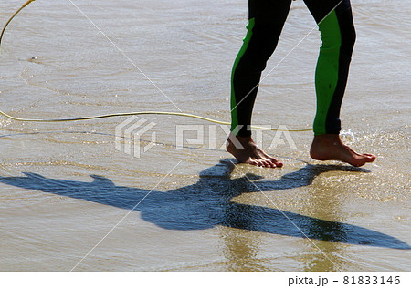 a man walks barefoot along a sandy beach on the shores of the mediterranean sea a man walks barefoot along a sandy beach on the shores of the mediterranean sea 81833146