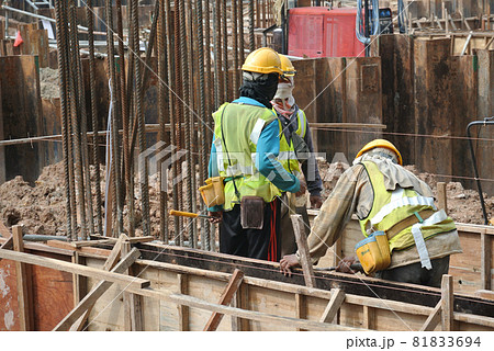 MALACCA, MALAYSIA -MAY 25, 2016: Construction workers fabricating timber form work at the construction site in Malacca, Malaysia. The form work was mainly made from timber and plywood. MALACCA, MALAYSIA -MAY 25, 2016: Construction workers fabricating timber form work at the construction site in Malacca, Malaysia. The form work was mainly made from timber and plywood. 81833694