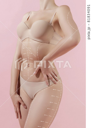 Cropped image of tanned young fit woman posing isolated over light pink studio background. The fitness, diet, sports, plastic surgery concept. Collage, flyer Cropped image of tanned young fit woman posing isolated over light pink studio background. The fitness, diet, sports, plastic surgery concept. Collage, flyer 81834091