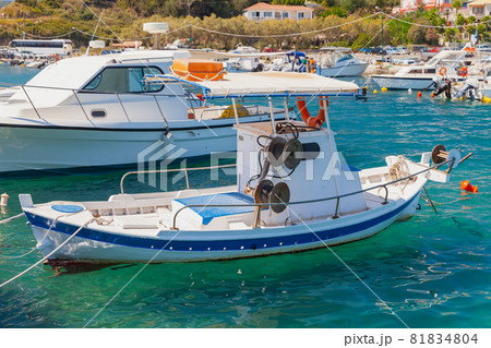 Small fishing boat is moored in port of Agios Sostis Small fishing boat is moored in port of Agios Sostis 81834804
