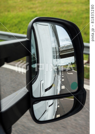 Road view from the side mirror. Traveling by car Road view from the side mirror. Traveling by car 81835280