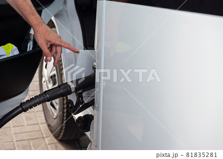 Car refueling on a petrol station with somebody 81835281