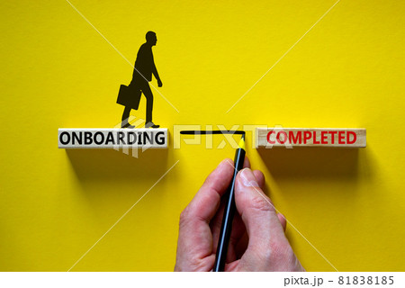 Onboarding completed symbol. Wooden blocks with words 'onboarding completed'. Businessman hand. Beautiful yellow background, copy space. Business and onboarding completed concept. Onboarding completed symbol. Wooden blocks with words 'onboarding completed'. Businessman hand. Beautiful yellow background, copy space. Business and onboarding completed concept. 81838185