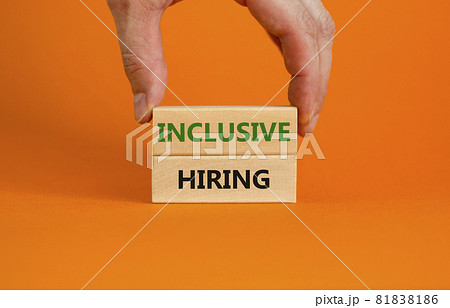 Inclusive hiring symbol. Wooden blocks with words Inclusive hiring on beautiful orange background. Businessman hand. Business, HR and inclusive hiring concept. Copy space. Inclusive hiring symbol. Wooden blocks with words Inclusive hiring on beautiful orange background. Businessman hand. Business, HR and inclusive hiring concept. Copy space. 81838186