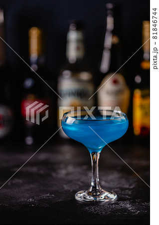 Blue cocktail / wine / champagne on a dark table 81846744